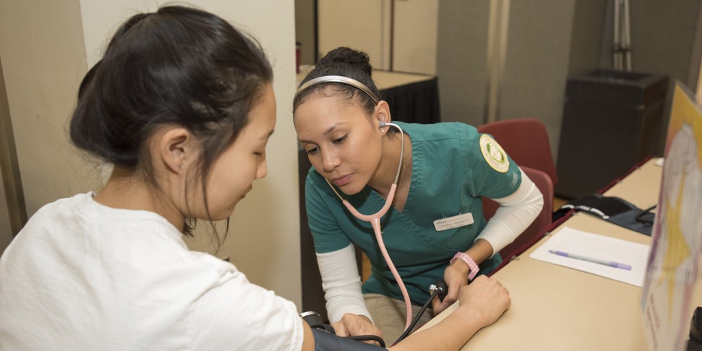 A student nurse measures blood pressure at the Health and Fitness Expo at the Fairfax Campus. Photo by Alexis Glenn/Creative Services/George Mason University