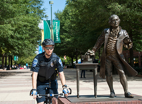 Police Officer Stuart Hensley on bicycle patrol at the Fairfax Campus.
